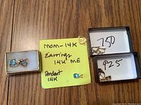 All lot items arranged on wooden table with handwritten note indicating markings