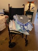 Front view of the Drive folding wheelchair with linens piled on seat.