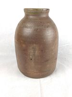 Front view of the antique salt glaze pot showing overall shape and surface texture.