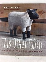 Front cover of the book showing a sheep folk art sculpture with the title and author.