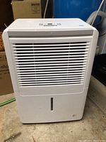 Front view of white dehumidifier with air vents.