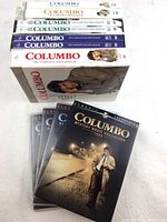 Photo showing the complete DVD collections for Columbo seasons 1-5 and mystery movie collections 1989 and 1990. Box sets stacked showing spines and DVD cases with Columbo images.