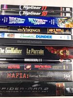 Photo showing the spines of 11 DVDs including Top Gear seasons, Back to the Future trilogy, Vikings, Crocodile Dundee, The Social Network, The Godfather, and Spider-Man 2.