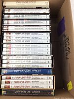 Photo showing all DVD sets arranged stacked, showing spines with season numbers and disc counts
