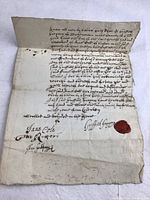 Full view of manuscript with text, fold lines and red wax seal.