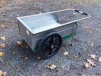 Full side view of the foldable aluminum garden cart showing overall condition and large wheel
