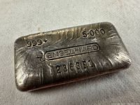 Obverse of bar showing purity stamp “999+”, weight “5.000”, Engelhard logo and serial 236381