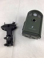 Closed view of Wingscapes Birdcam Pro camera and clamp tripod showing camera front with logo and clamp mount.