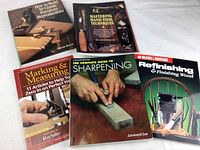 Five woodcraft books laid flat showing titles and covers.