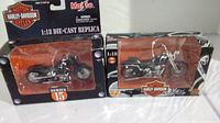 Photo of two Maisto 1:18 scale diecast Harley-Davidson motorcycles in boxes, showing Series 2 and Series 15 labels.