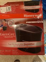Photo showing the Honeywell top fill warm mist humidifier box with branding and product details visible.