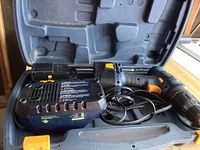 Mastercraft cordless drill, battery, and charger inside a black plastic carrying case.