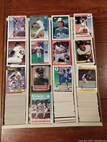 Four batches of baseball cards arranged in rows showing the front card of each row with player images and set details.