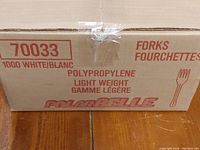 Sealed cardboard box labeled '1000 White Forks, Polypropylene, Lightweight' with brand PolarBelle.