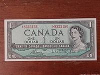Front side of 1954 Canadian one dollar bill showing Queen Elizabeth II portrait, serial number, and text.