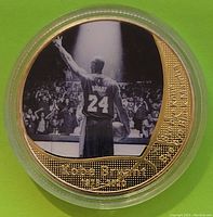 Front side of commemorative coin showing Kobe Bryant in Lakers jersey #24 from the back with crowd and text 'Kobe Bryant 1978 - 2020'