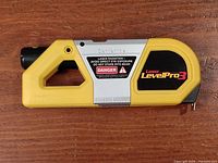Full side view of Laser LevelPro 3 laser level showing yellow and silver body, handle, and warning label.