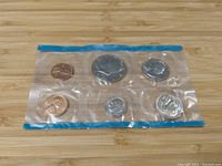 Full view of sealed plastic pouch containing six 1972 USA coins: Kennedy Half Dollar, Quarter, Dime, Nickel, and two Pennies.