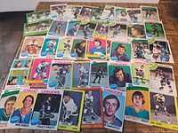 Spread of approximately 35 vintage Vancouver Canucks hockey cards showing various players and card designs from the 1970s era.