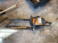 Poulan Pro chain saw including the main body with an orange and black design and the bar with 'Power Care' branding.