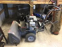 Photo showing the entire snow blower unit including discharge chute, engine and handles.