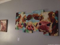 Overall view of barn animal-themed wall art including multi-panel cow canvas, framed pig print, Central Perk sign, and chicken sign.