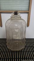 Front overview of the clear glass 1 gallon jug showing the embossed 'Barnes' name and the overall shape and design.