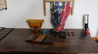 Photo showing the whole lot arranged on wooden table including watches, wallets, bracelet, and glass bowl.