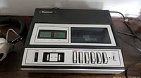 Vintage cassette player showing tape deck, VU meters, and control buttons