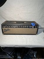 Front view of entire amplifier head showing tolex, grille cloth, control panel and handle