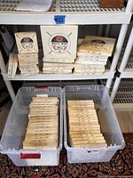 Full view of 62 boxes of XLO music wire stacked on shelves and inside bins with visible labels showing wire gauge and weight per box.