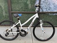 Full side profile of the white Marin Stinson comfort bicycle showing step-through frame, wheels, saddle and drivetrain