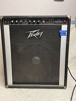 Full front view of PEAVEY Bass Combo 260 Series amplifier showing grill, logo, corners and power cable connected.