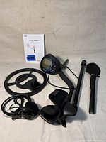 Full set of RoHS MD-830(P) metal detector components laid out including coil, control unit, shaft, armrest, headphones, and manual.