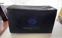 Front view of black Creative Memories rolling case with logo.