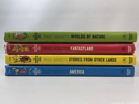 Four Walt Disney hardcover books with colorful spines and titles visible for identification.