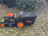 Side profile of mower showing entire unit with grass catcher attached