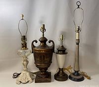 Four vintage table lamps arranged side by side showing varied styles and distinct decorative details