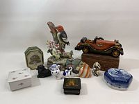 Photo showing the complete set of vintage trinkets including porcelain boxes, animal figurines, a bird on floral base, and wooden model car on wooden base