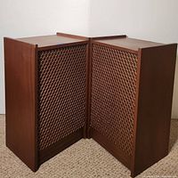 Pair of two wooden vintage speakers placed side by side, showing front grille design and wood side finish.