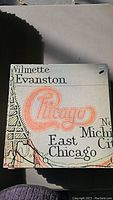 Close-up photo of Chicago album cover with city names and stylized band name