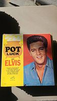 Front cover of 'Pot Luck with Elvis Presley' vinyl record album featuring Elvis on the cover with a yellow and red themed design.