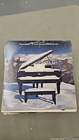 Top record cover showing a piano in a snowy mountain scene with text "Supertramp - Even In The Quietest Moments..."