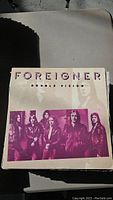 Close-up photo of Foreigner 'Double Vision' vinyl record cover showing artwork and some wear.