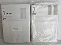 Photo showing two unopened IKEA curtain sets labeled Hilja and Lill