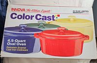 Box showing Innova Color Cast 4.5 Quart Oval Oven with porcelain enamel cast iron cookware and 25 year limited warranty.