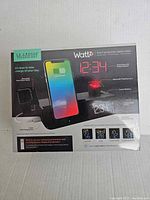 La Crosse Wattz 3-in-1 Projection Alarm Clock box showing product features including projection clock, wireless charging, weather icons, Bluetooth speaker, and temperature/humidity sensor.