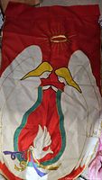 Red garden flag showing two white angels with golden halo and white dove