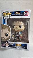 Front image of Marvel Thor Ragnarok Funko Pop figure in original sealed box showing figure holding a guitar and box number 240.