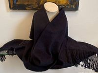Dark alpaca scarf draped on a mannequin, fully visible showing softness and size.